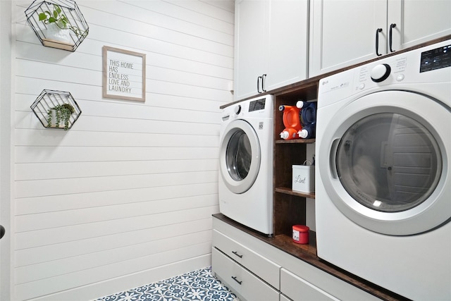 1500 Ranger Rd, Aubrey, TX 76227 - laundry area featuring washer and clothes dryer, cabinet space, and wooden walls