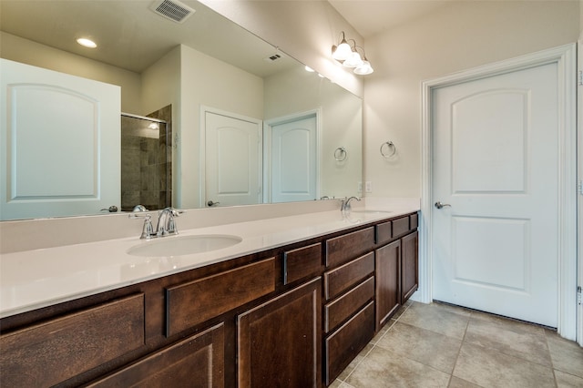 1130 Pasatiempo Dr, Frisco, TX 75036 - bathroom with double vanity, a stall shower, tile patterned flooring, and recessed lighting