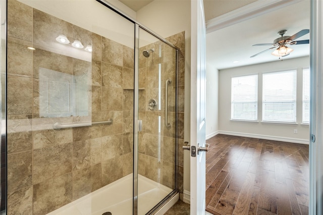 1130 Pasatiempo Dr, Frisco, TX 75036 - bathroom with a ceiling fan, a stall shower, wood finished floors, and baseboards