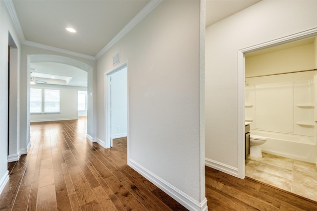 1130 Pasatiempo Dr, Frisco, TX 75036 - hall featuring arched walkways, dark wood-style flooring, ornamental molding, baseboards, and recessed lighting