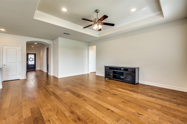 1130 Pasatiempo Dr, Frisco, TX 75036 - unfurnished living room with a raised ceiling, arched walkways, ceiling fan, ornamental molding, and recessed lighting