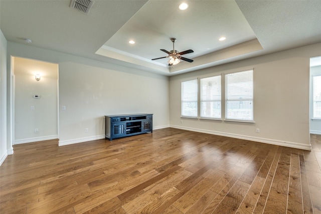 1130 Pasatiempo Dr, Frisco, TX 75036 - unfurnished living room featuring a raised ceiling, wood finished floors, a ceiling fan, baseboards, and recessed lighting