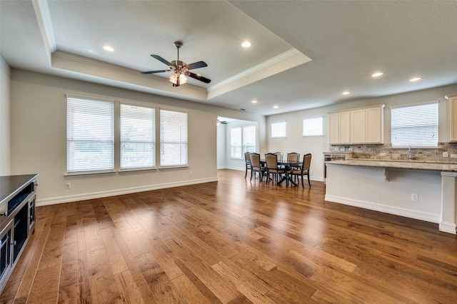 1130 Pasatiempo Dr, Frisco, TX 75036 - living room featuring crown molding, a tray ceiling, a ceiling fan, hardwood / wood-style floors, and recessed lighting