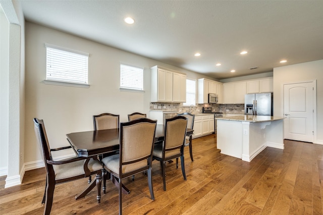 1130 Pasatiempo Dr, Frisco, TX 75036 - dining area with hardwood / wood-style flooring, recessed lighting, and baseboards