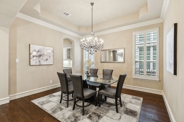 5924 Heron Bay Ln, Mckinney, TX 75070 - dining room with visible vents, arched walkways, wood finished floors, and a tray ceiling