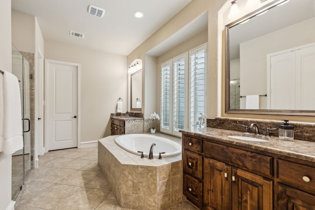 5924 Heron Bay Ln, Mckinney, TX 75070 - bathroom with visible vents, a shower stall, a sink, and a garden tub