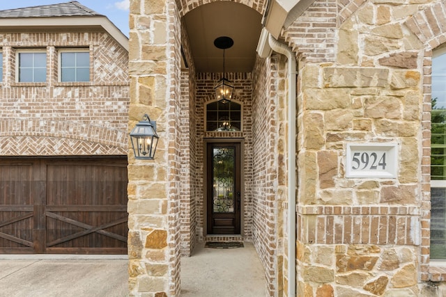 5924 Heron Bay Ln, Mckinney, TX 75070 - property entrance with brick siding, stone siding, and a garage