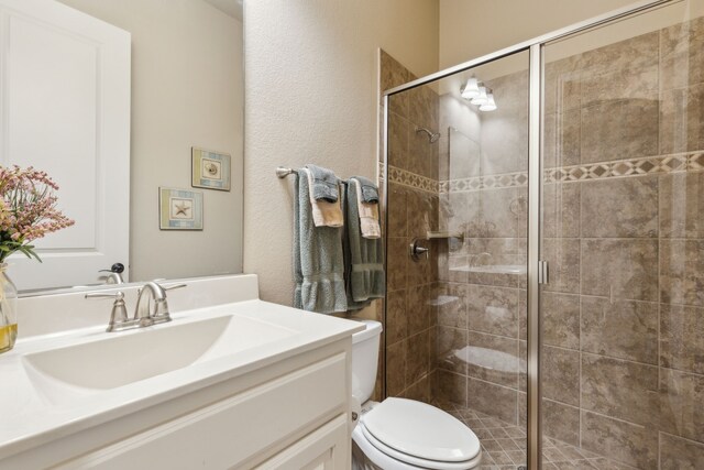 5924 Heron Bay Ln, Mckinney, TX 75070 - bathroom featuring vanity, toilet, and a stall shower