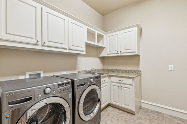 5924 Heron Bay Ln, Mckinney, TX 75070 - laundry area featuring washer and clothes dryer, cabinet space, light tile patterned flooring, and baseboards