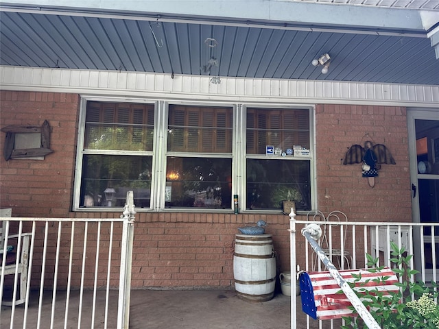 view of exterior entry featuring brick siding