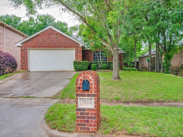 view of front of property with brick siding, a front yard, and concrete driveway