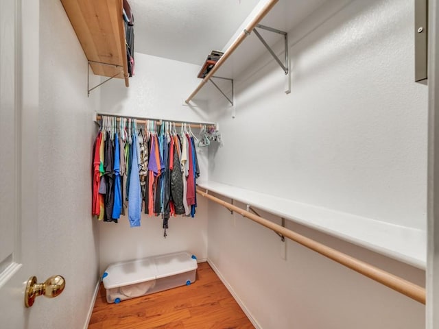 walk in closet featuring light wood finished floors