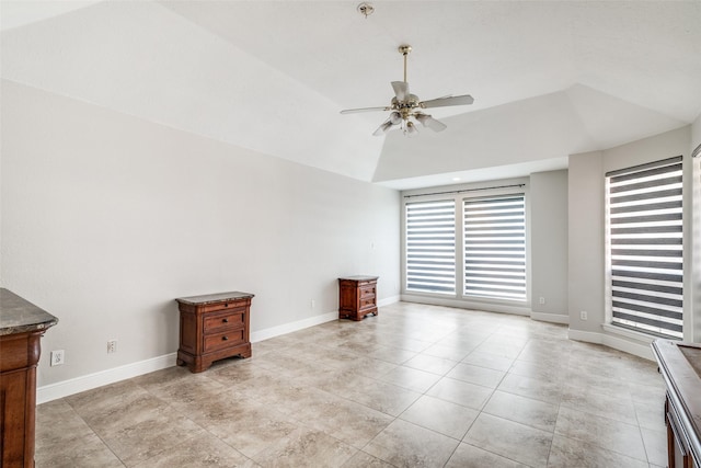 unfurnished room featuring baseboards, ceiling fan, light tile patterned flooring, and vaulted ceiling