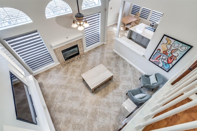 living area with a towering ceiling and a fireplace