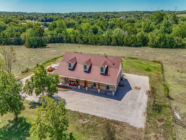 drone / aerial view with a wooded view