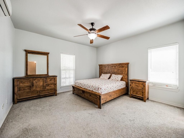 carpeted bedroom featuring baseboards, ceiling fan, and an AC wall unit