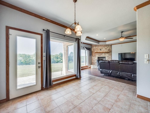 living room featuring light tile patterned floors, baseboards, ornamental molding, and ceiling fan with notable chandelier