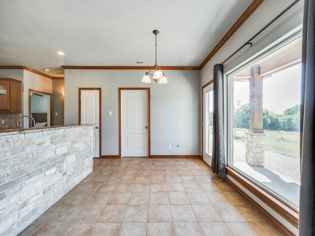 interior space featuring visible vents, crown molding, baseboards, an inviting chandelier, and light tile patterned flooring