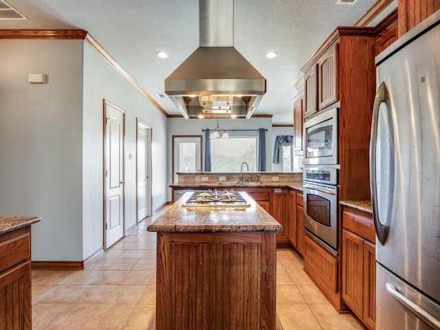 kitchen featuring appliances with stainless steel finishes, ornamental molding, a peninsula, and island exhaust hood