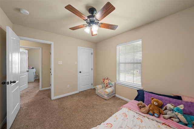 carpeted bedroom with baseboards and ceiling fan