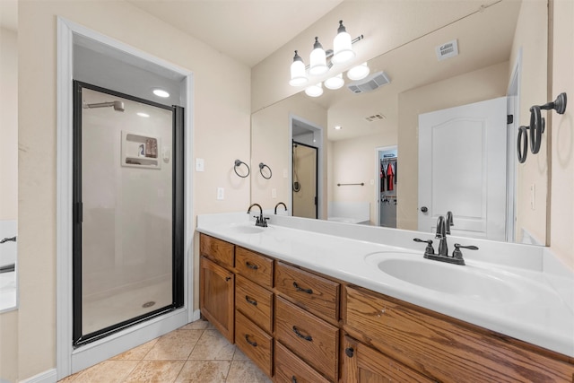 full bath with visible vents, a shower stall, and a sink