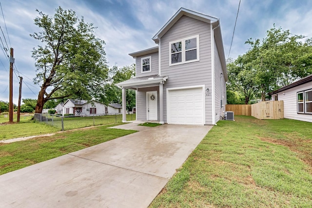 traditional-style home with a garage, fence, driveway, and a front lawn