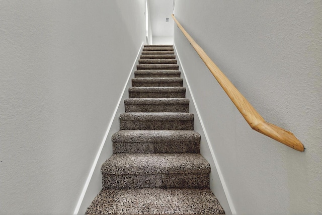 staircase with a textured wall