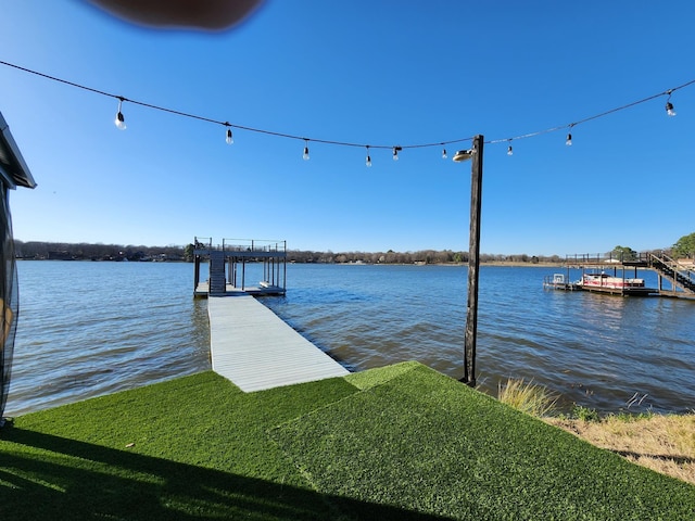 view of dock with boat lift and a water view
