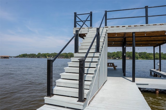 view of dock featuring a water view and stairs