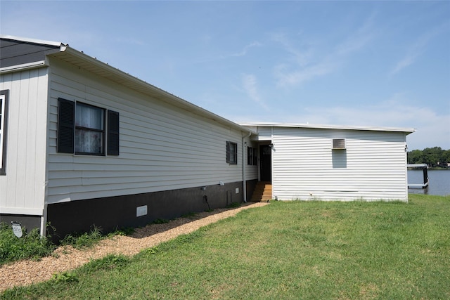 view of property exterior with a lawn and crawl space
