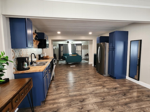 kitchen with dark wood-style flooring, blue cabinetry, stainless steel refrigerator with ice dispenser, a sink, and wood counters