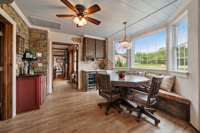8121 Cahoba Dr, Fort Worth, TX 76135 - dining space featuring breakfast area, crown molding, wine cooler, light wood-style flooring, and ceiling fan