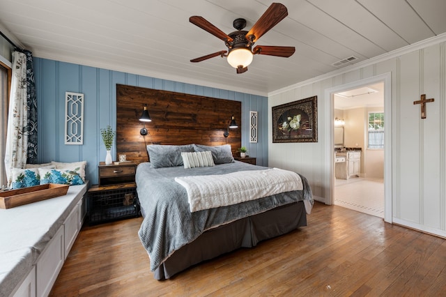 8121 Cahoba Dr, Fort Worth, TX 76135 - bedroom featuring ornamental molding, hardwood / wood-style floors, ceiling fan, ensuite bathroom, and a decorative wall