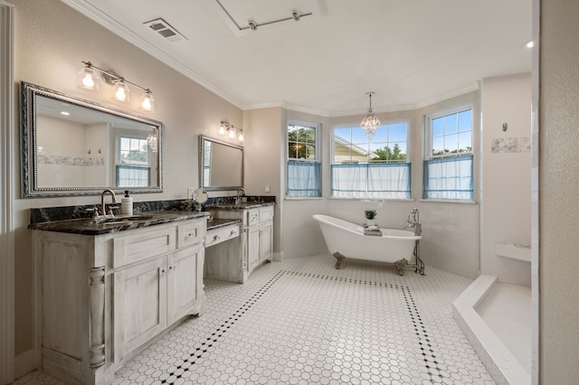 8121 Cahoba Dr, Fort Worth, TX 76135 - full bathroom featuring crown molding, a freestanding tub, double vanity, and a chandelier