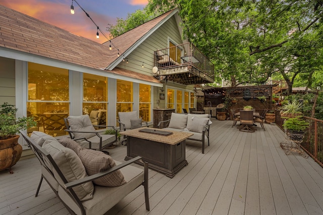 8121 Cahoba Dr, Fort Worth, TX 76135 - deck at dusk with an outdoor living space with a fire pit and outdoor dining space