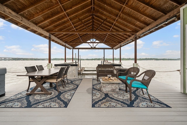 8121 Cahoba Dr, Fort Worth, TX 76135 - wooden deck featuring a water view, a fire pit, boat lift, and a boat dock