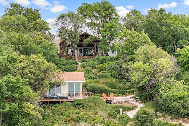 8121 Cahoba Dr, Fort Worth, TX 76135 - rear view of house featuring a fire pit, a wooden deck, and a view of trees
