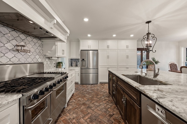 8121 Cahoba Dr, Fort Worth, TX 76135 - kitchen with stainless steel appliances, custom exhaust hood, a sink, backsplash, and brick patterned floors