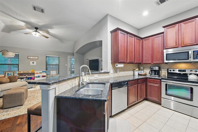 452 Northbrook Ave, Oak Point, TX 75068 - kitchen featuring visible vents, dark brown cabinets, open floor plan, a sink, and appliances with stainless steel finishes
