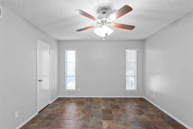 4211 Fairway Dr, Granbury, TX 76049 - unfurnished room with a textured ceiling, ceiling fan, baseboards, and stone finish floors