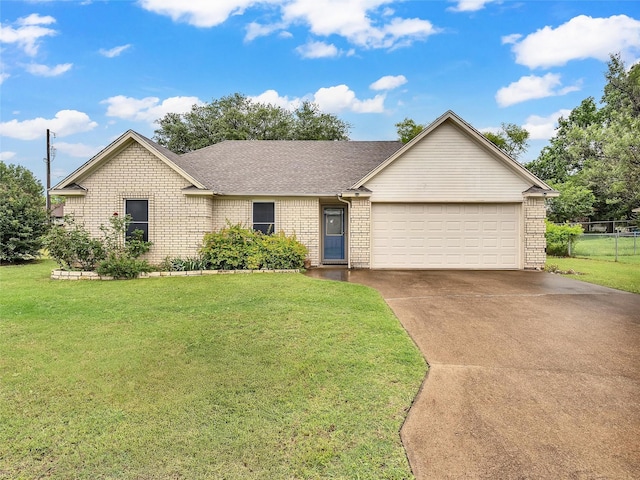 ranch-style home with a garage, concrete driveway, a front yard, and brick siding