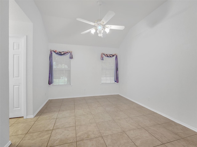 spare room featuring a ceiling fan, baseboards, vaulted ceiling, and light tile patterned floors