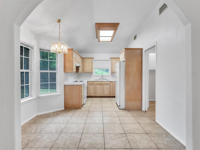kitchen featuring light brown cabinets, white appliances, light countertops, a sink, and a notable chandelier