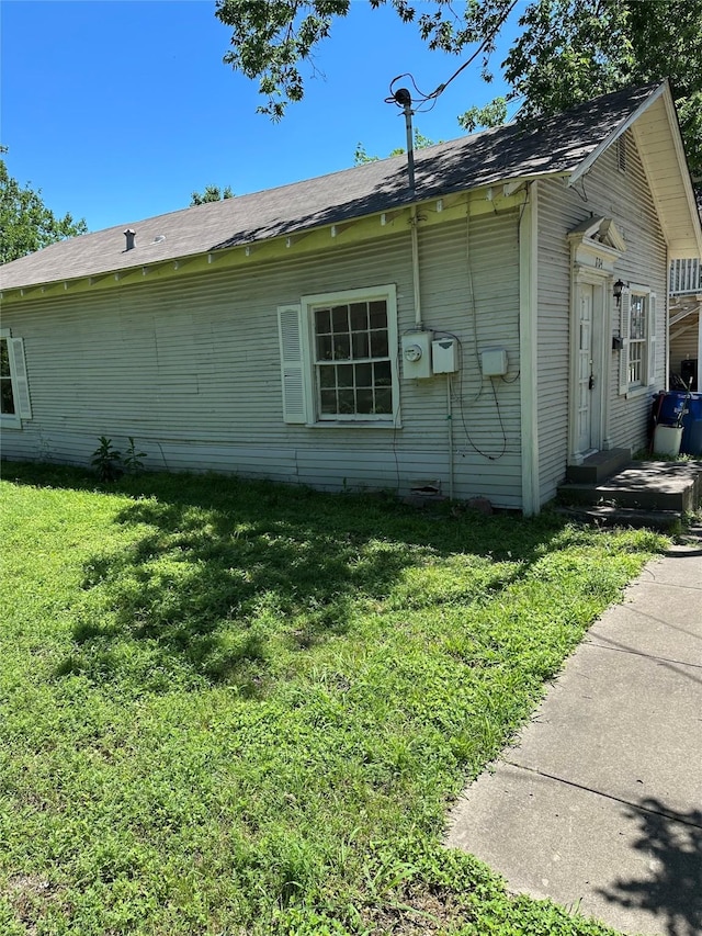 view of side of property with a lawn
