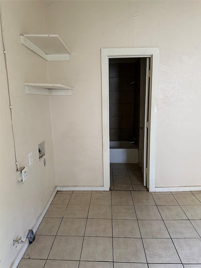 laundry area featuring washer hookup, baseboards, laundry area, and light tile patterned flooring