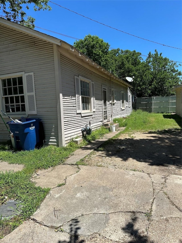 view of home's exterior with fence