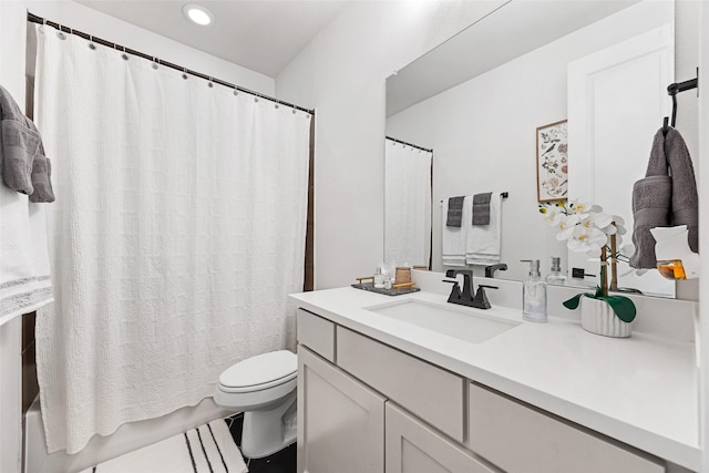 bathroom with vanity, recessed lighting, shower / bathtub combination with curtain, and toilet
