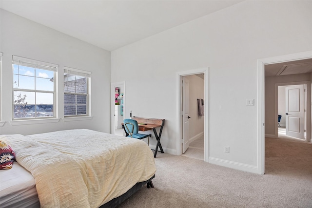 bedroom with carpet floors, baseboards, and attic access
