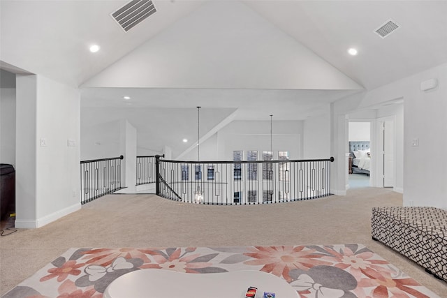 hall with visible vents, recessed lighting, carpet floors, and high vaulted ceiling