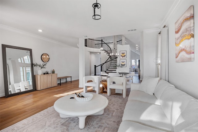 living room featuring visible vents, wood finished floors, stairway, ornamental molding, and recessed lighting